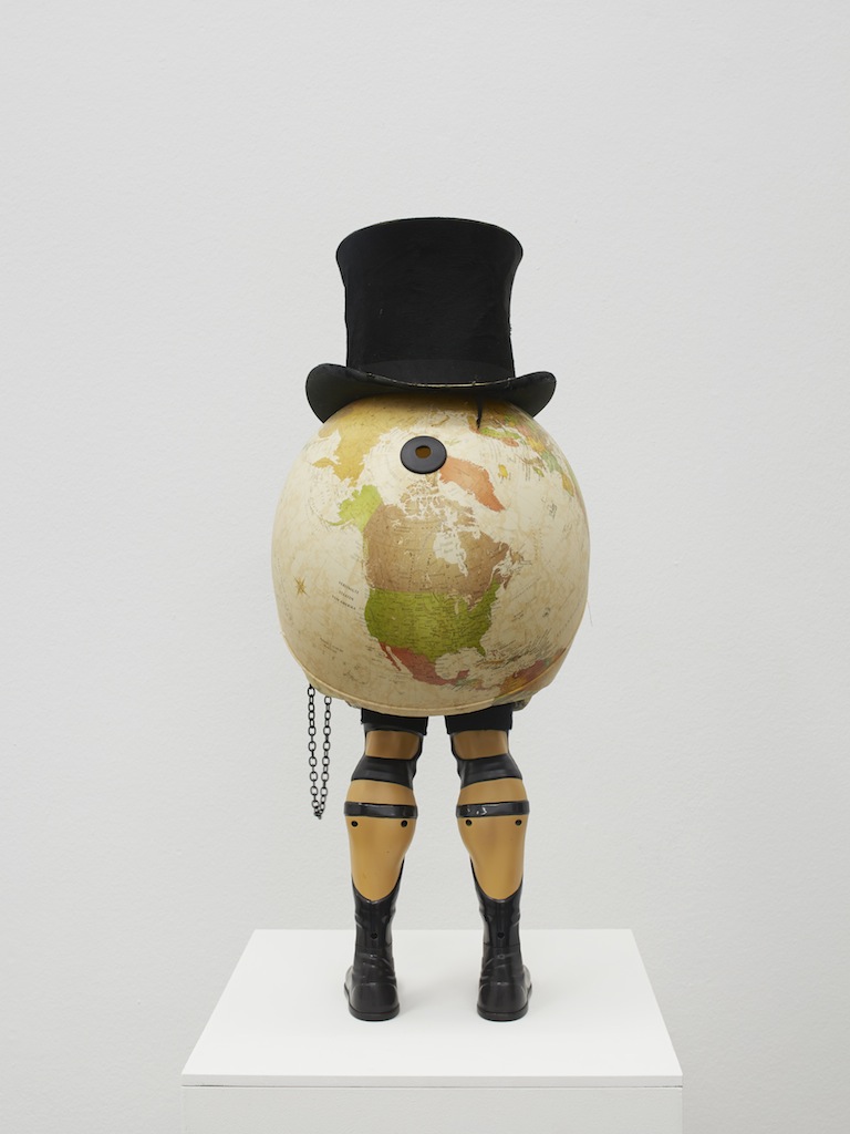 Danny McDonald, <i>The Speculator</i>, 2015, antique top hat, styrofoam skull, wrestler legs, glass monocle, chain, crystal, broken globe, 73 x 40 x 30 cm